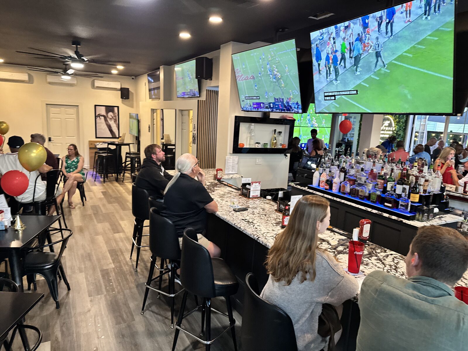 Guests gathered at The District's bar with the game on the screens