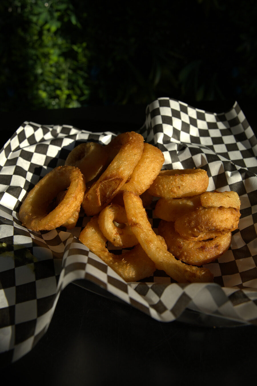 Basket of onion rings with dipping sauce
